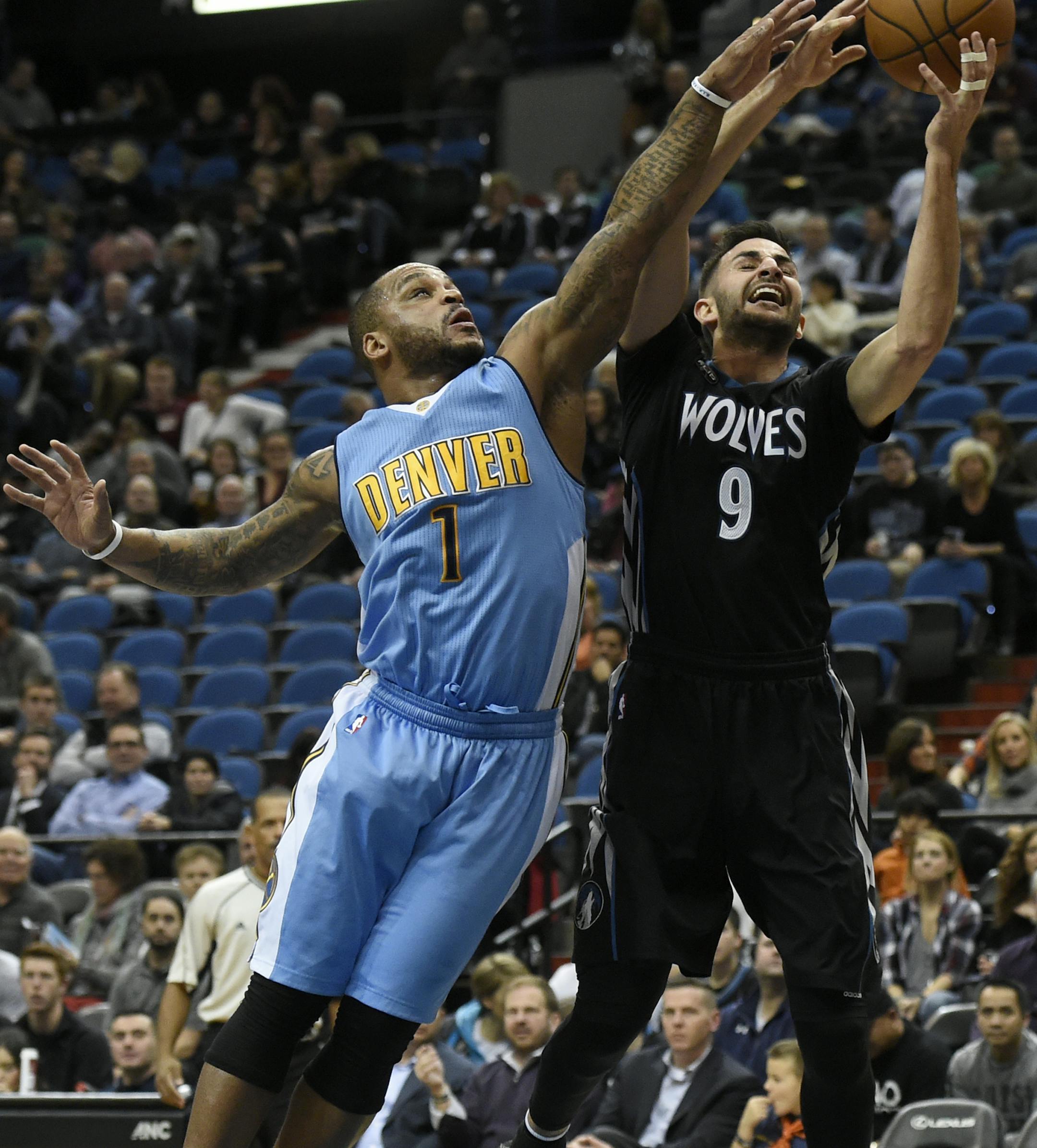 Denver Nuggets guard Jameer Nelson (1) fouls Minnesota Timberwolves guard Ricky Rubio (9), of Spain, on a shot during the first quarter of an NBA basketball game Tuesday, Dec. 15, 2015, in Minneapolis. (AP Photo/Hannah Foslien)
