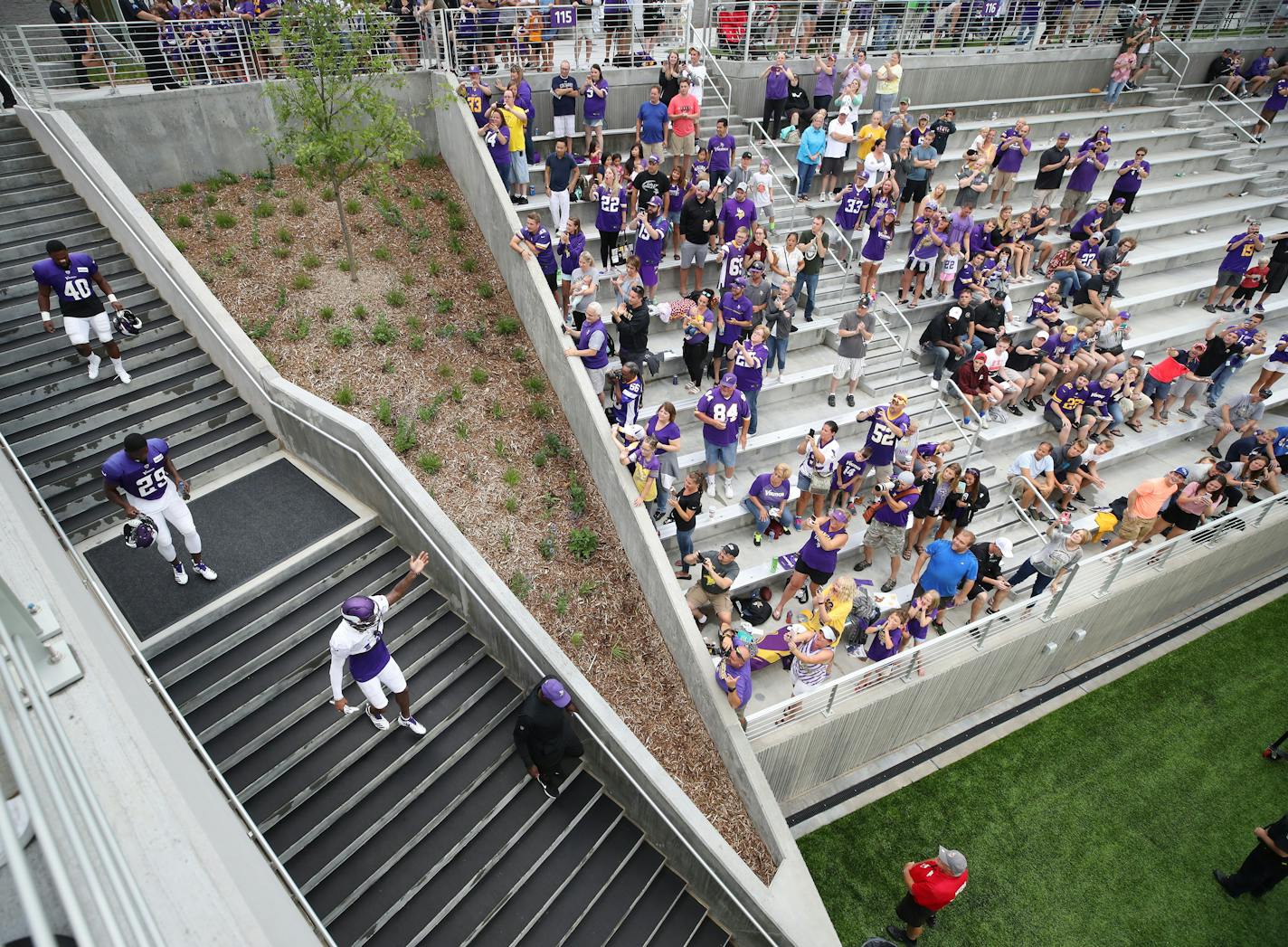 Minnesota Vikings wide receiver Stefon Diggs (14) waves to the fans as he enters the stadium at a night practice during the team's training camp at TCO Performance Center.