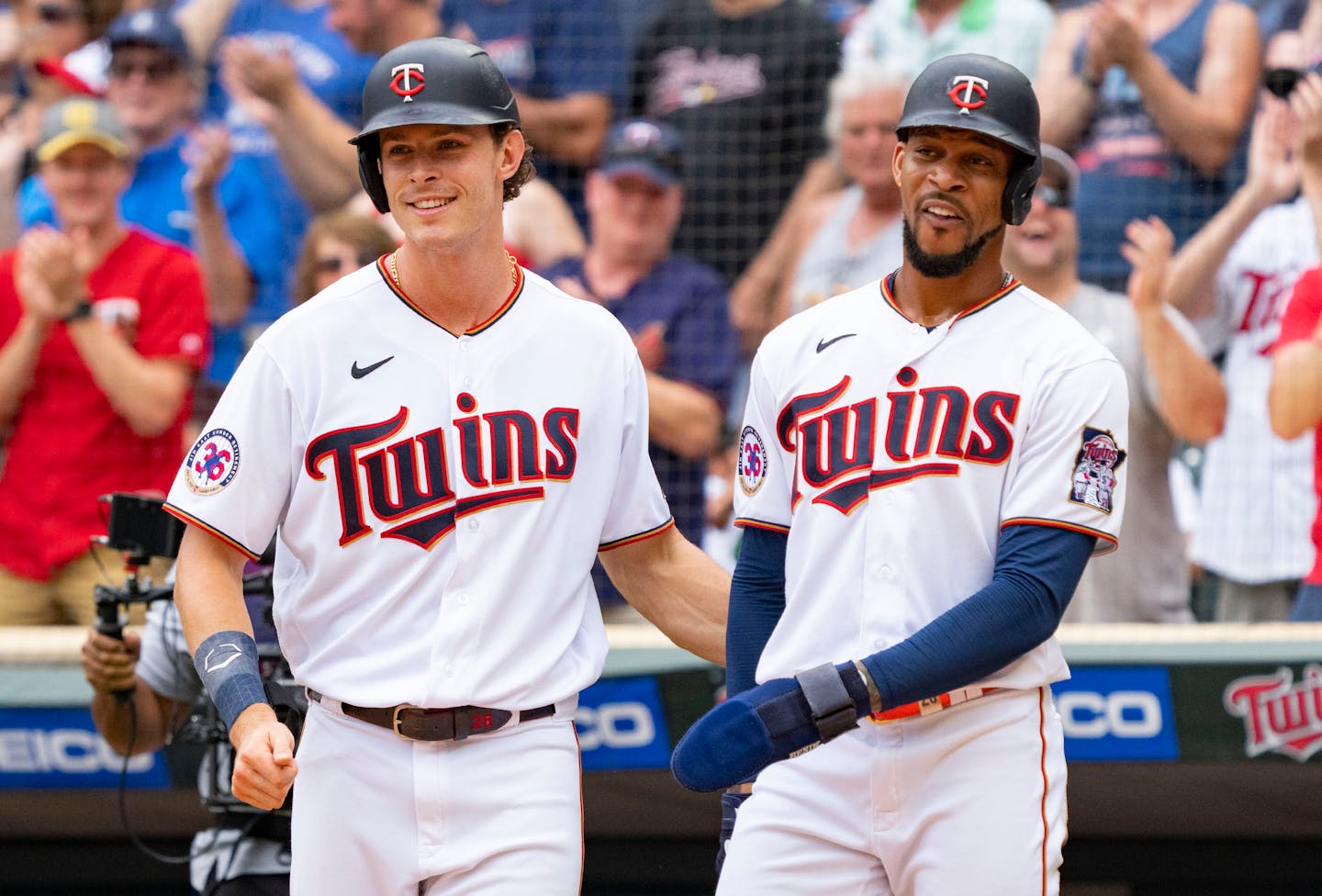 Minnesota Twins right fielder Max Kepler (26) and designated hitter Byron Buxton (25) celebrate after scoring off a three-run home run from second baseman Jorge Polanco (11) in the third inning against the Chicago White Sox Saturday, July 16, 2022 at Target Field in Minneapolis. ]