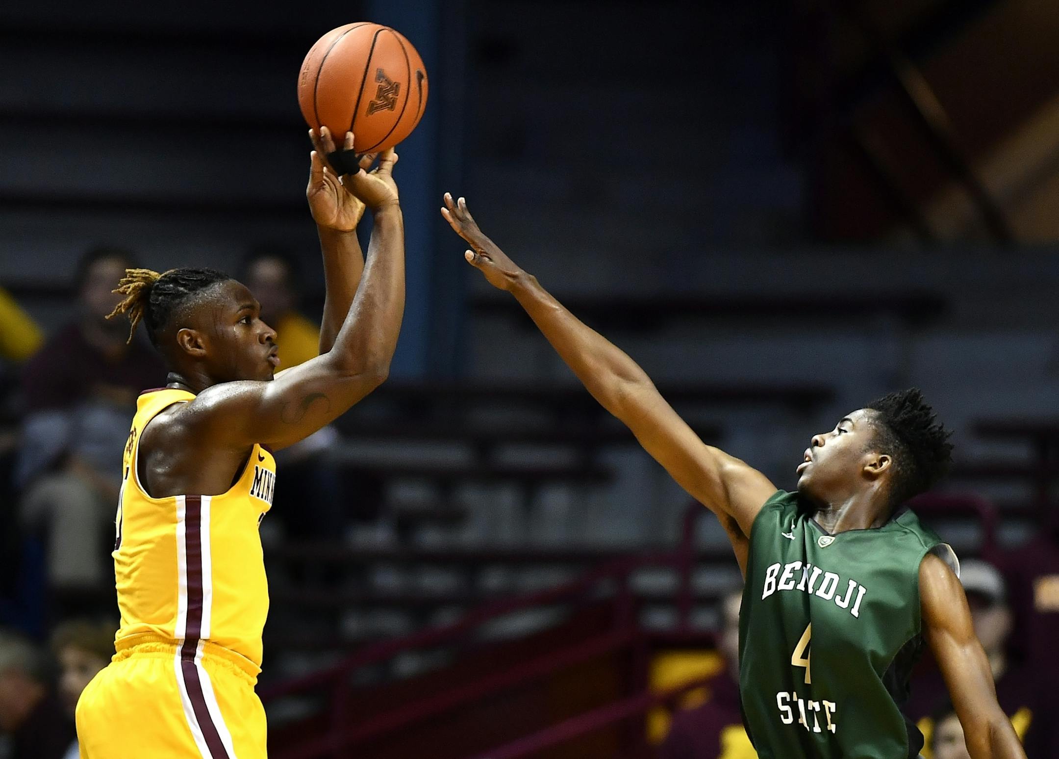 Minnesota Golden Gophers guard Akeem Springs, left.