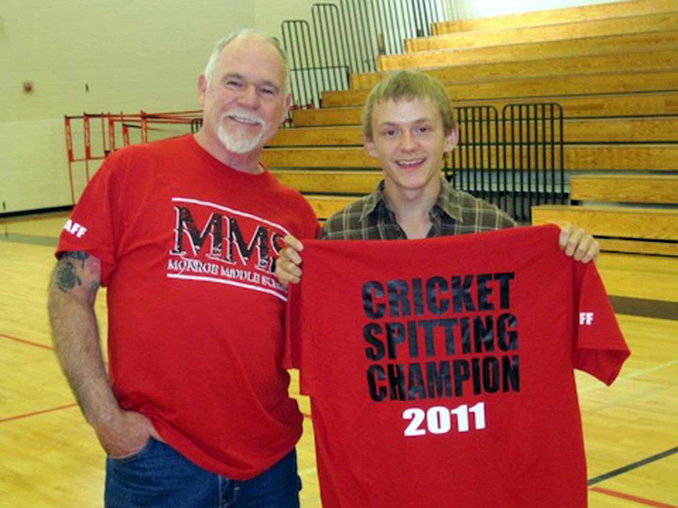 Cricket spitting world-record holder Dan Capps poses with a middle-school winner in 2011. (Photo by Jeff and Dan Capps)