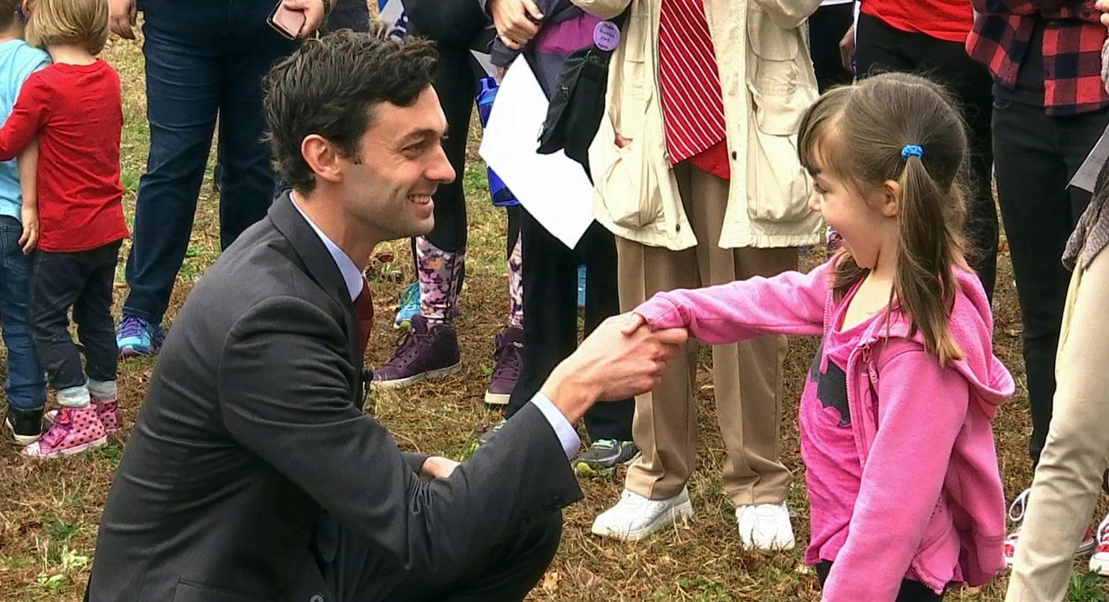 In a Monday, March 27, 2017 photo, Democratic congressional candidate Jon Ossoff is seen with supporters outside of the East Roswell Branch Library in Roswell, Ga., on the first day of early voting. President Donald Trump is attacking Ossoff, the leading Democratic candidate for a special election in a typically conservative Georgia congressional district, with Republicans bidding to avoid a major upset. On Twitter, Trump said Monday April 17, 2017, that "The super Liberal Democrat in the Georgi