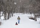 Jeff Booron of Minneapolis pulled his son Hendrick on a sled near the bridge that crosses to Pike Island at Fort Snelling State Park in 2015.