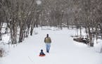Jeff Booron of Minneapolis pulled his son Hendrick on a sled near the bridge that crosses to Pike Island at Fort Snelling State Park in 2015.