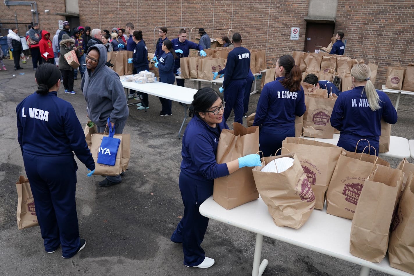 Minneapolis Police Department community service officers handed out bags of food during the free grocery giveaway event Wednesday at the Minneapolis Police Activities League.