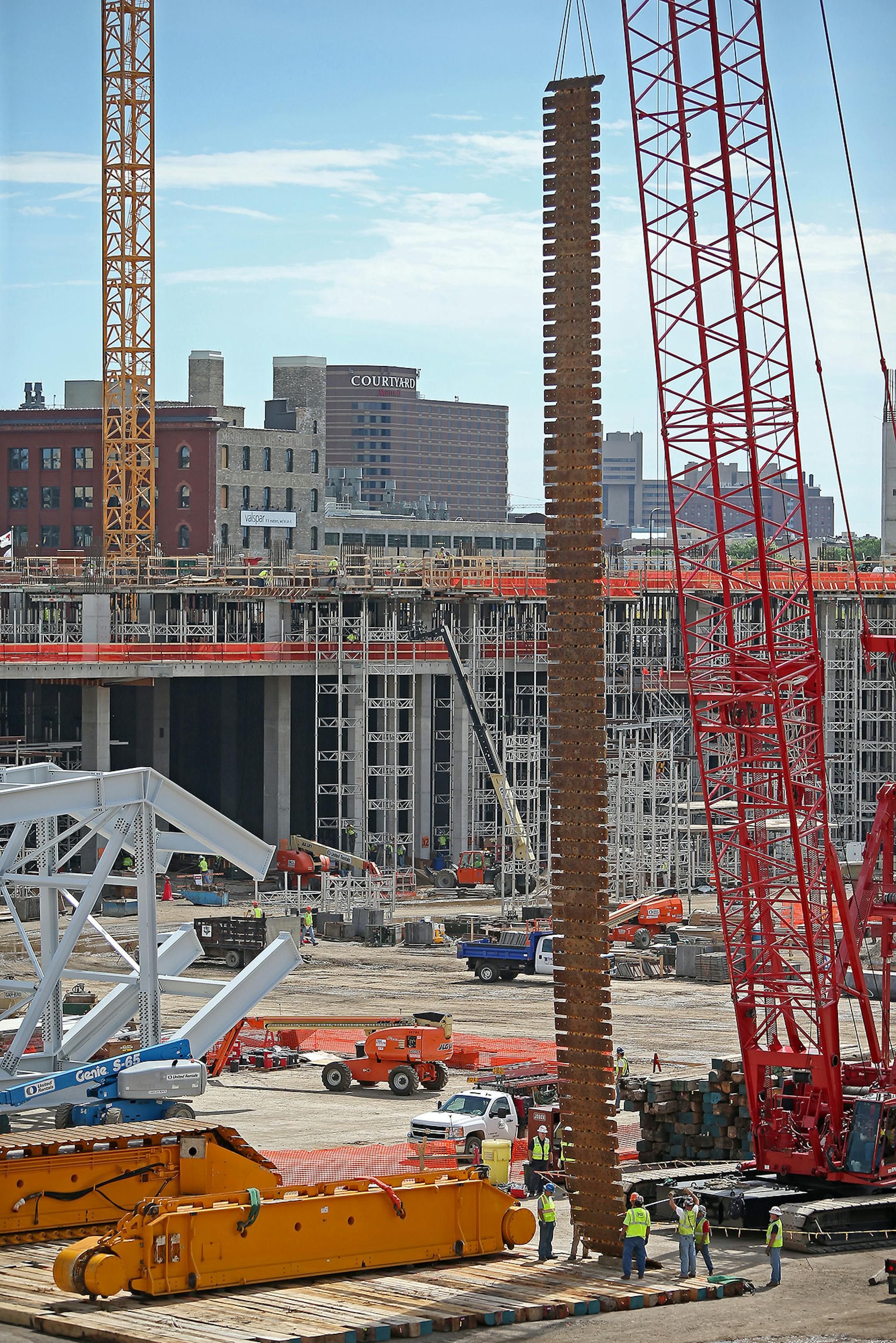 Construction crews began assembling the 8-foot-high base that a 400-foot crane will sit on at the site of the future Minnesota Multipurpose Stadium. The crane itself, arriving in 69 truckloads, will take three weeks to put together.