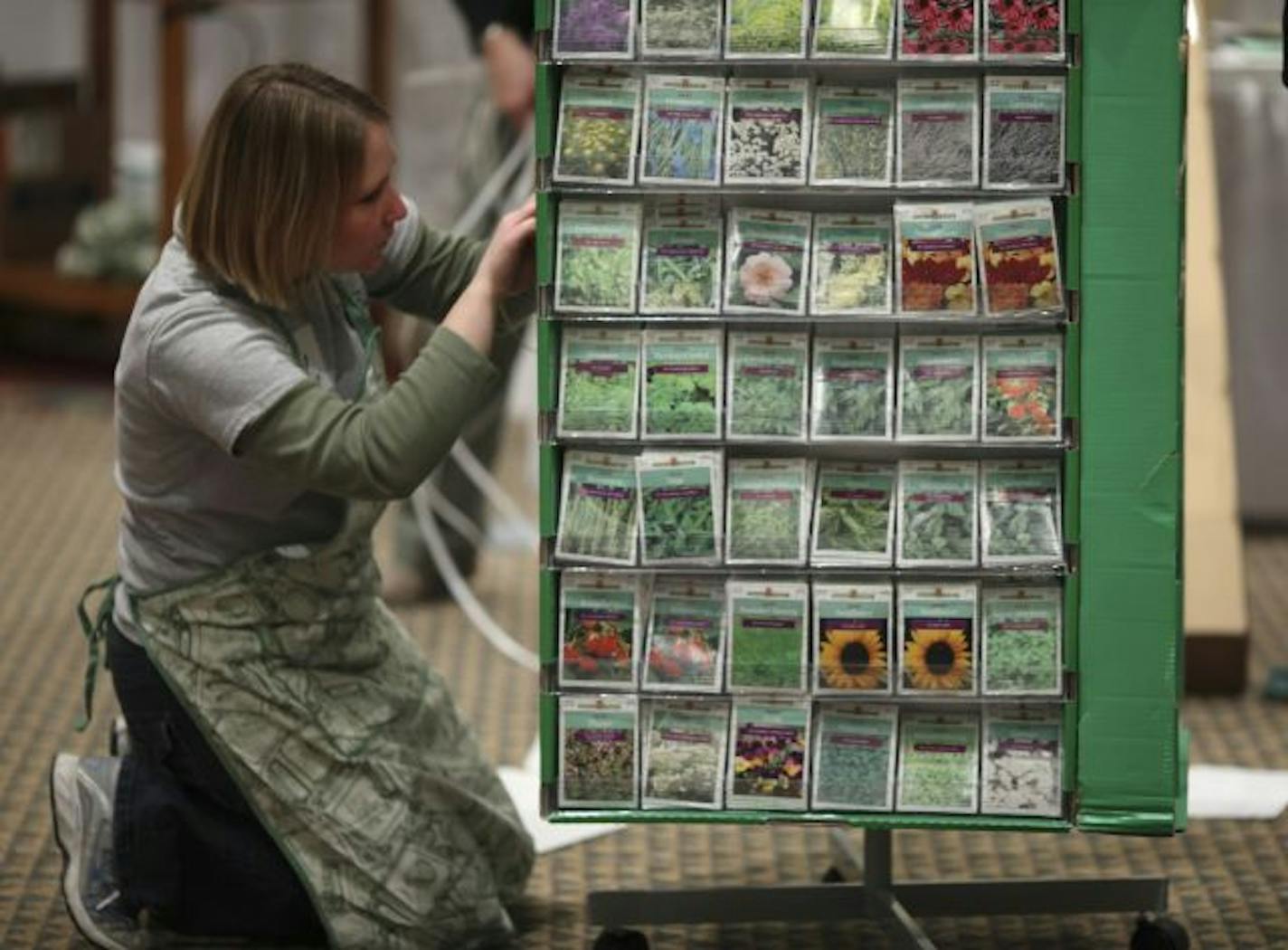 Rachel Kinny, a volunteer at the State Horticultural Society exhibit, arranged seed packets at the Minneapolis Home & Garden Show on Wednesday.