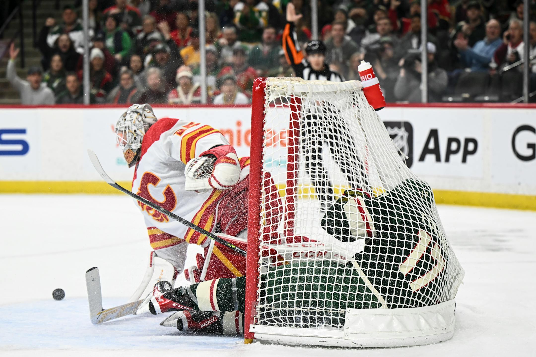 Minnesota Wild left wing Marcus Foligno (17) falls to the ice after he was penalized by Calgary Flames defenseman Noah Hanifin (55), leading to a power play during the first period.