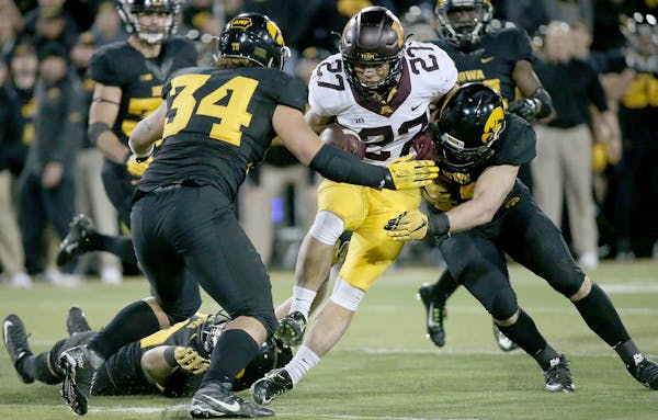Minnesota's running back Shannon Brooks carried the ball for a first downin the fourth quarter at Kinnick Stadium, Saturday, November 14, 2015 in Iowa