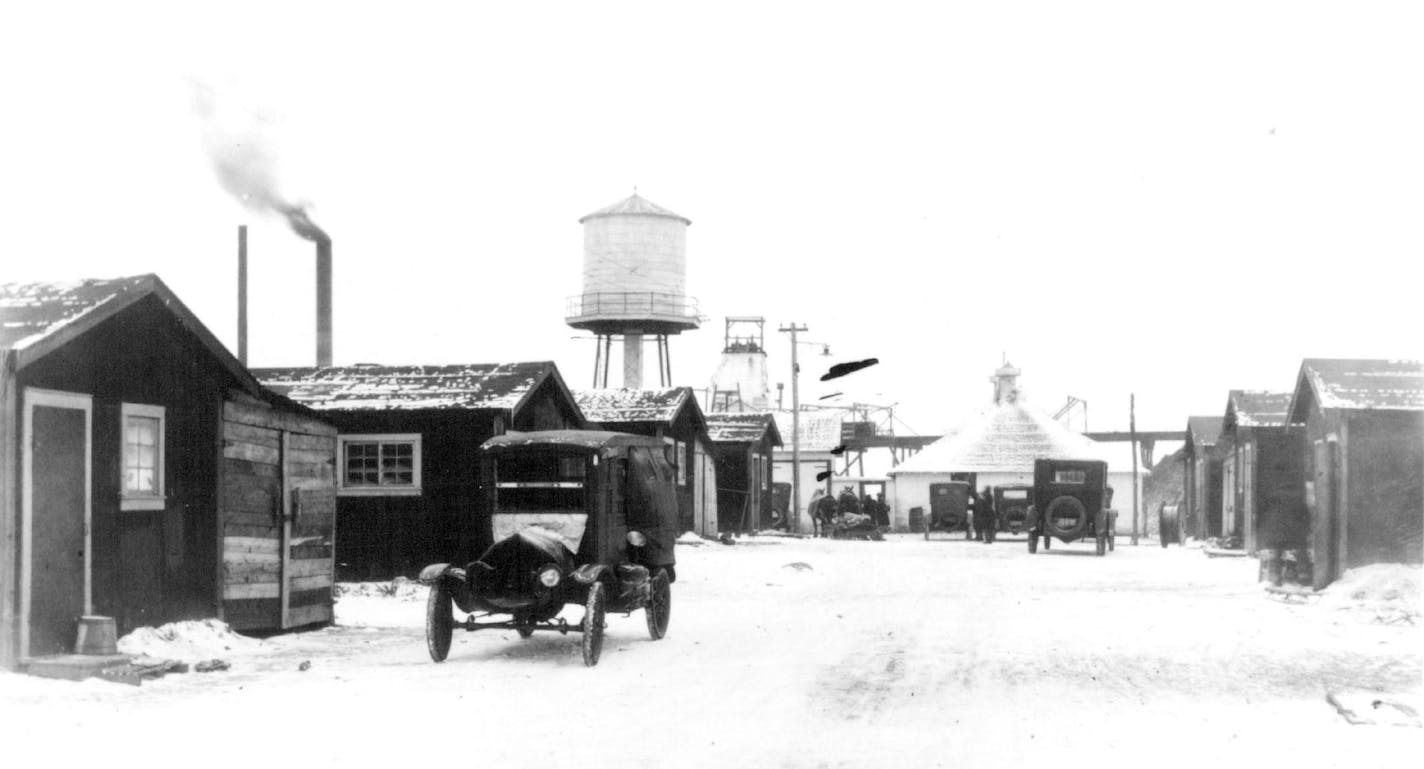 February 6, 1924 MINNESOTA HISTORICAL SOCIETY Main Street at Milford location and lake which flooded mine. St. Louis County, Buildings and Residences Mining Locations. Minnesota Historical Society ORG XMIT: MIN2015100918111746