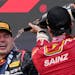 Third place Ferrari driver Carlos Sainz sprays champagne on Red Bull driver Max Verstappen in Japan on Sunday.