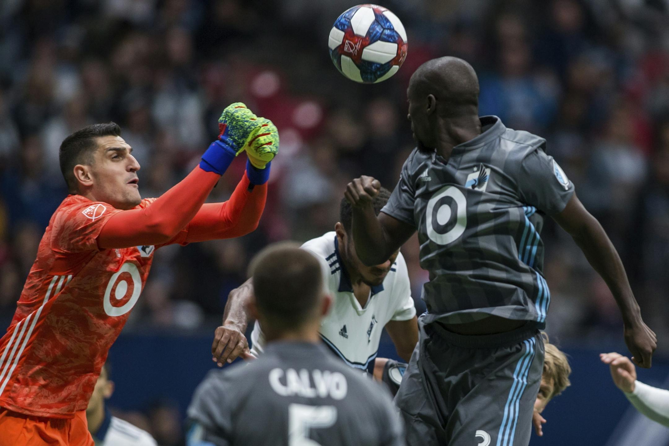 Minnesota United goalkeeper Vito Mannone (1) makes a save near teammate Ike Opara (3) dduring the second half of an MLS soccer match against the Vancouver Whitecaps on Saturday, March 2, 2019, in Vancouver, British Columbia.