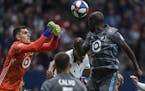 Minnesota United goalkeeper Vito Mannone (1) makes a save near teammate Ike Opara (3) dduring the second half of an MLS soccer match against the Vanco