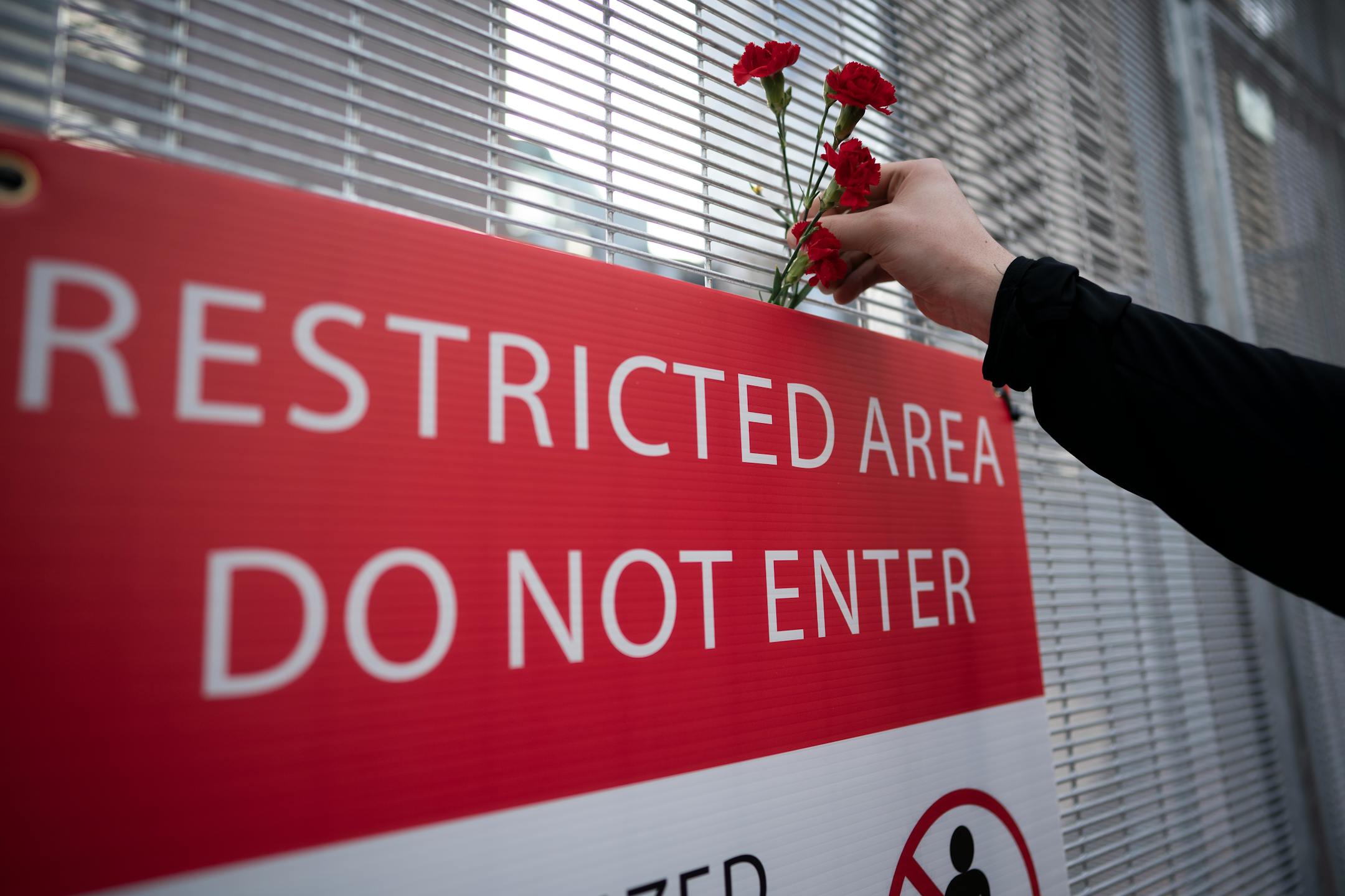 Flowers were placed  on the fence in front of the Hennepin County Government Center one day before jury selection is set to begin in the trial of former Minneapolis officer Derek Chauvin.