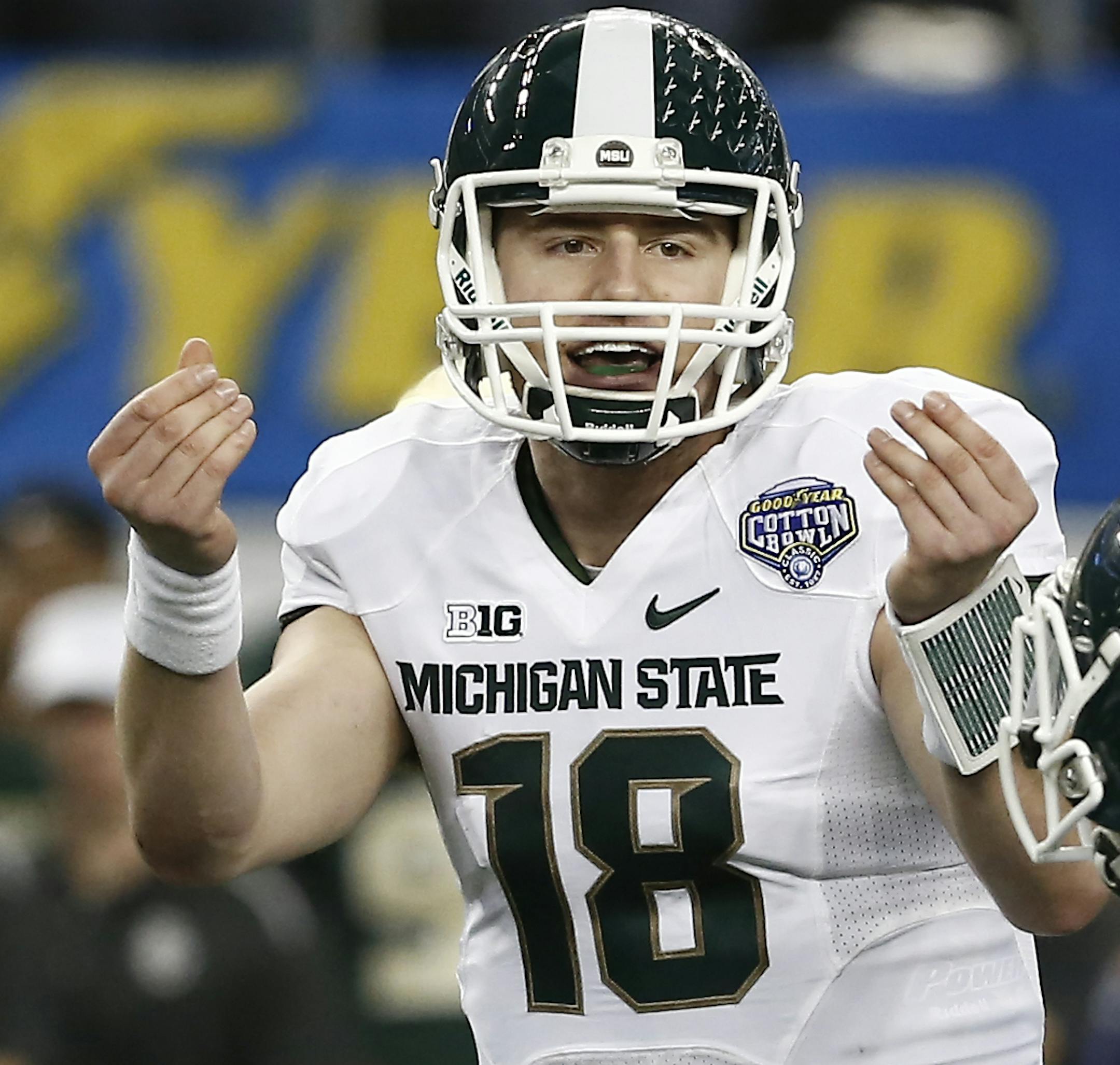 Michigan State quarterback Connor Cook (18) signals to his teammates during the second half of the Cotton Bowl NCAA college football game against Baylor, Thursday, Jan. 1, 2015, in Arlington, Texas. Michigan State won 42-41. (AP Photo/Brandon Wade)