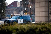 A police car waits on campus at the University of Minnesota after receiving deadly threats by a man saying he was going to target the U on Thursday, J