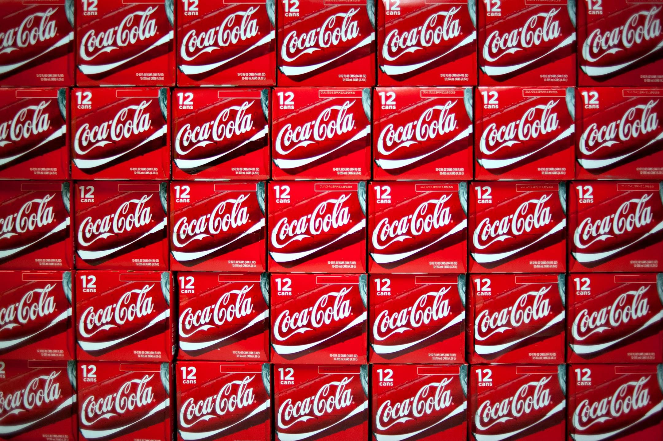 Twelve-packs of Coca-Cola Co. soda sit on display in a supermarket in Princeton, Illinois, U.S., on Friday, Oct. 12, 2012. Coca-Cola Co. is scheduled to release earnings data on Oct. 16. Photographer: Daniel Acker/Bloomberg