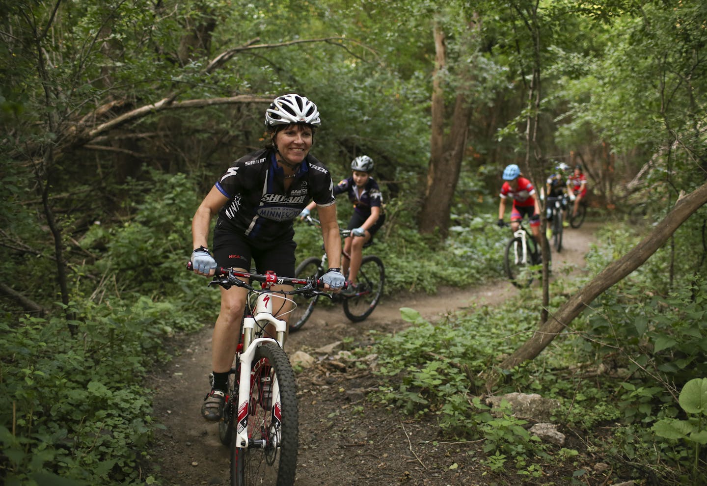 Martha Flynn, director of Crank Sisters, an outreach program of the Minnesota High School Cycling League, led a group of young women who ride for high school mountain bike teams on a trail in Theodore Wirth Park Wednesday evening. ] JEFF WHEELER &#xef; jeff.wheeler@startribune.com Martha Flynn, director of Crank Sisters, led a group of young women who ride for high school mountain bike teams on a trail in Theodore Wirth Park Wednesday evening, August 26, 2015 in Minneapolis.