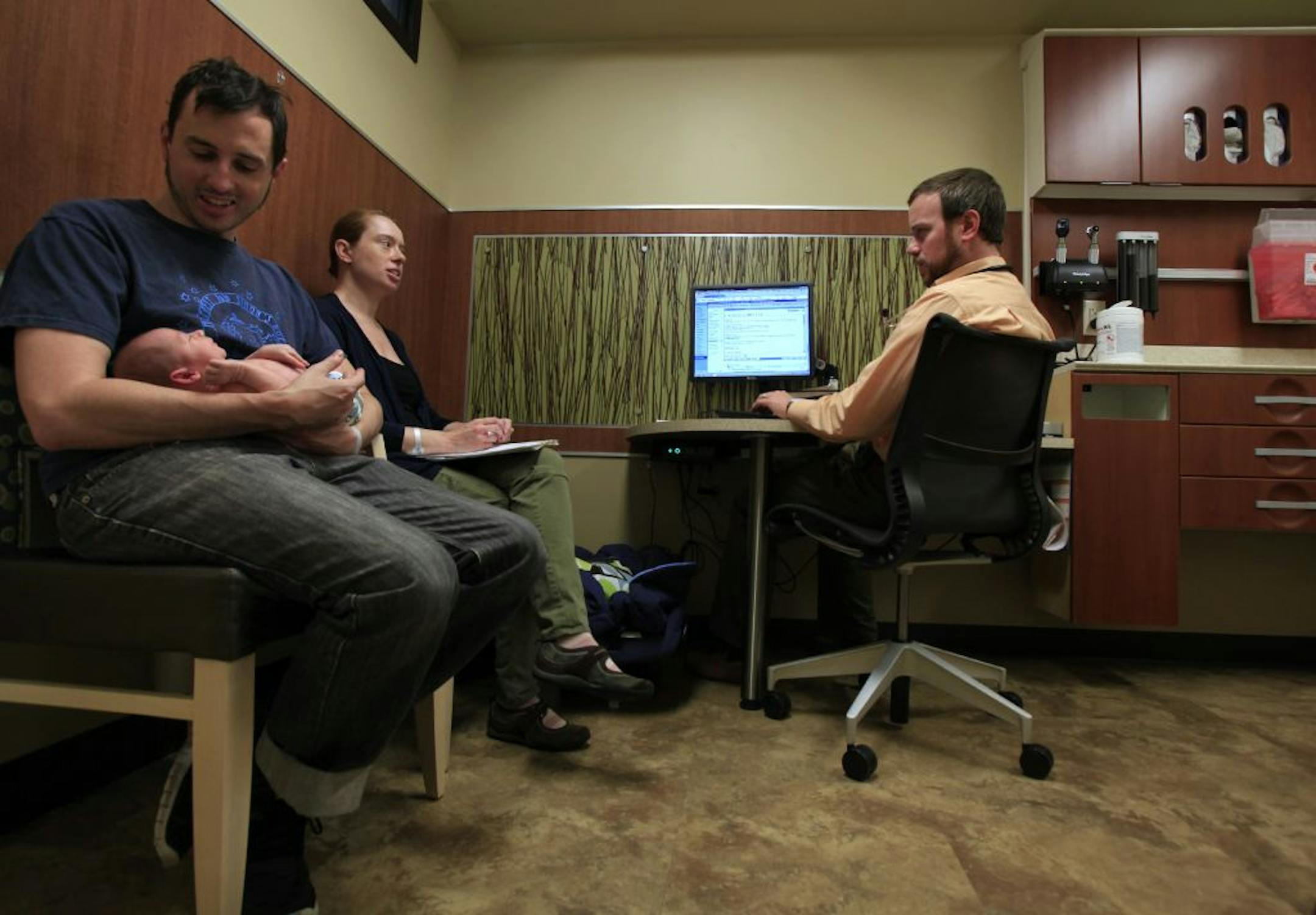 Cathy Beil asked Dr. Ian Kenning questions as Gregg Beil held 14 day old Galen Beil before his two week exam in the HealthPartners Nokomis Clinic at 4730 Chicago Avenue South, Minneapolis MN on Novenmber 8, 2012.