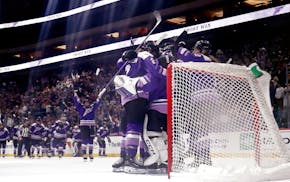 Frost players celebrate after their playoff victory over the Sceptres on Sunday at Xcel Energy Center. The Frost took a 2-1 lead in the best-of-seven