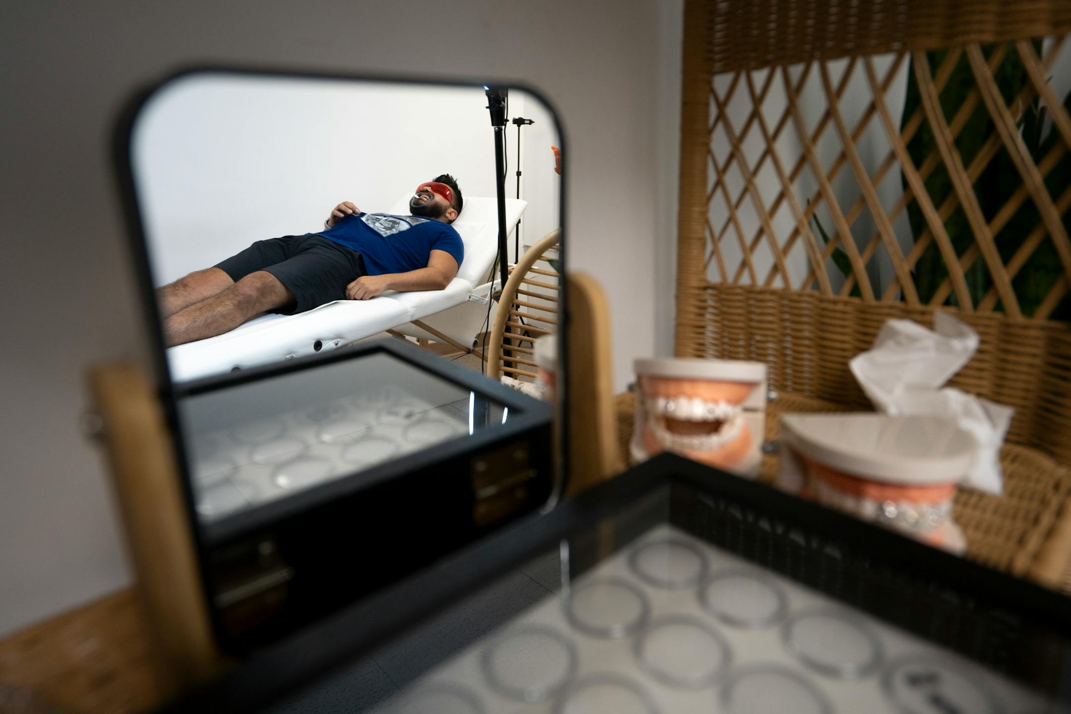 Andrew Montez starts a tooth gem session with Mirna Lovo, owner of Pearly Whites MN, in Burnsville, Minn. on Thursday, June 29, 2023.