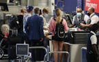 Travelers at the Delta Air Lines ticketing counter Thursday at Minneapolis-St. Paul International Airport.