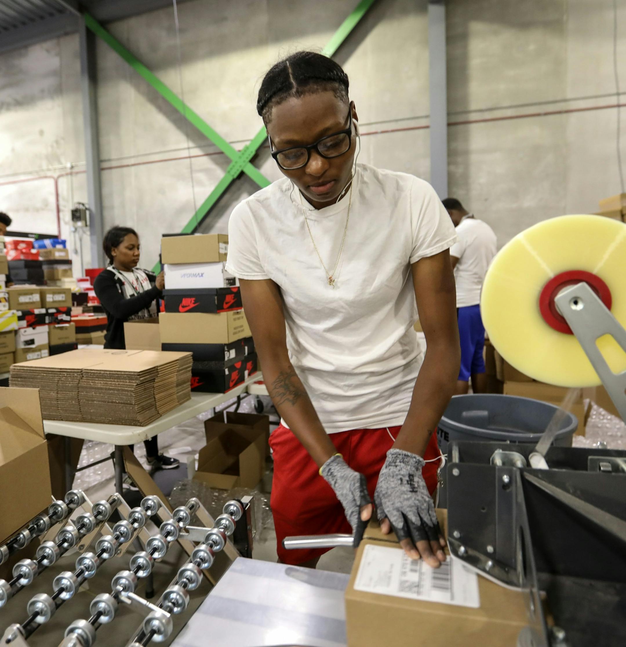 Calais Sewell, 27, of Detroit prepares authenticated goods for shipping at the new Stock X authentication center in Detroit on Tuesday, July 3, 2018. Sewell says she tries to be the "Go-to" at Stock X, that has created day trading for consumer goods and is doing $2 million in sales daily. (Kimberly P. Mitchell/Detroit Free Press/TNS) ORG XMIT: 1235460