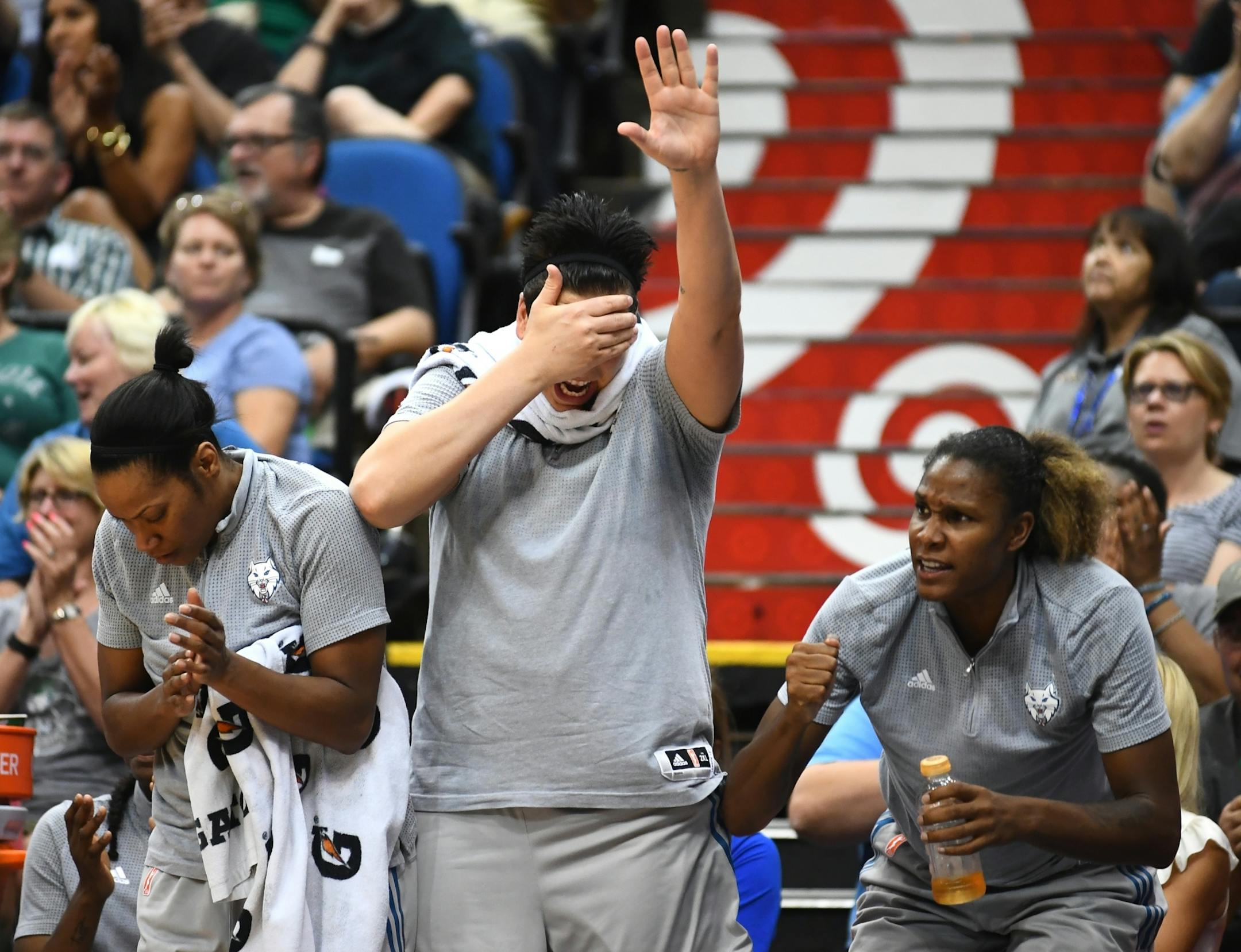 From left, Minnesota Lynx guard Jia Perkins (7), Janel McCarville (4) and forward Rebekkah Brunson (32) celebrated a layup by forward Natasha Howard (3) against the Seattle Storm in the fourth quarter Friday.