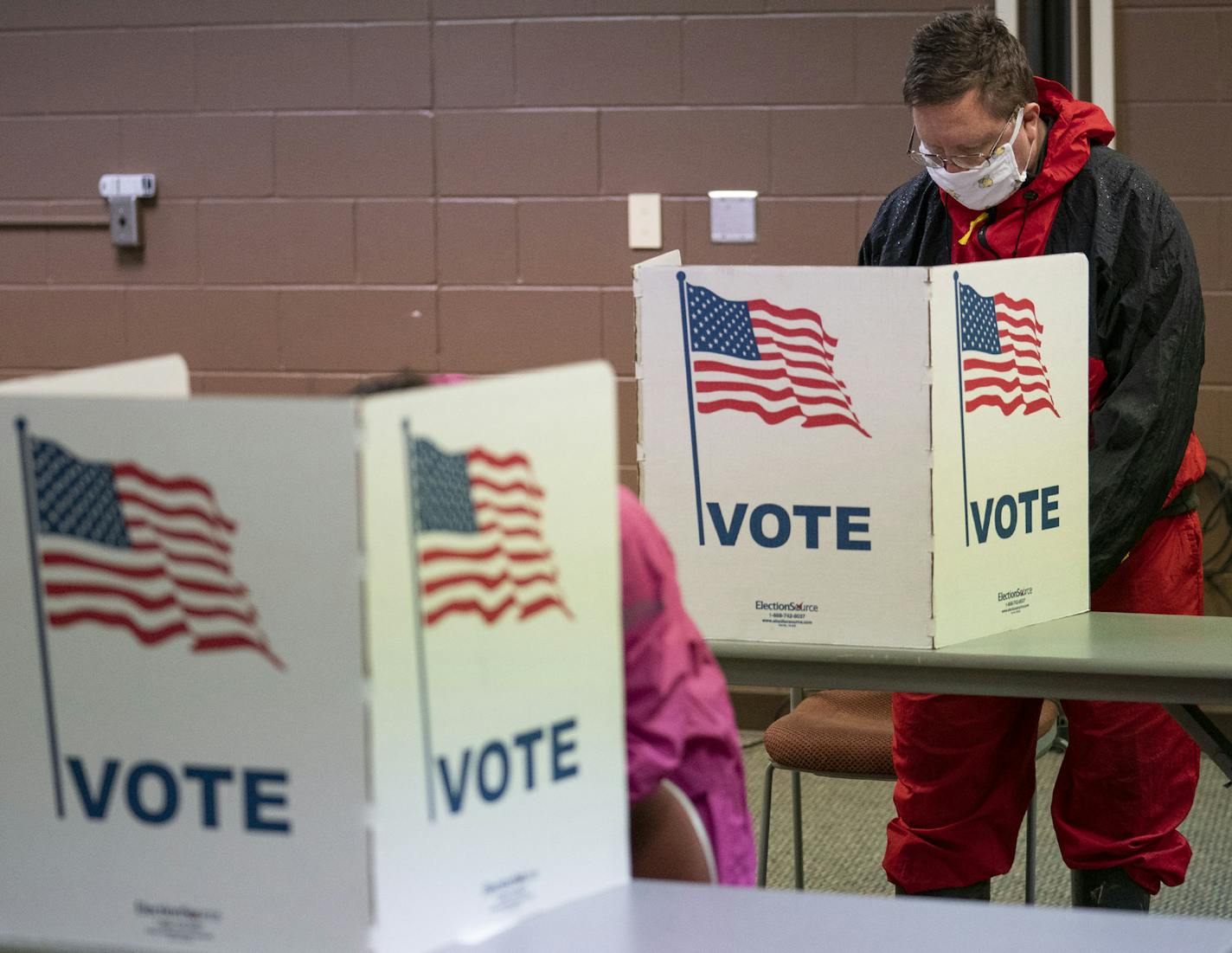 Sanghee and Abram Pauna filled out their ballots at the WITC Convention Center in Superior, Wis., on Tuesday, April 7.