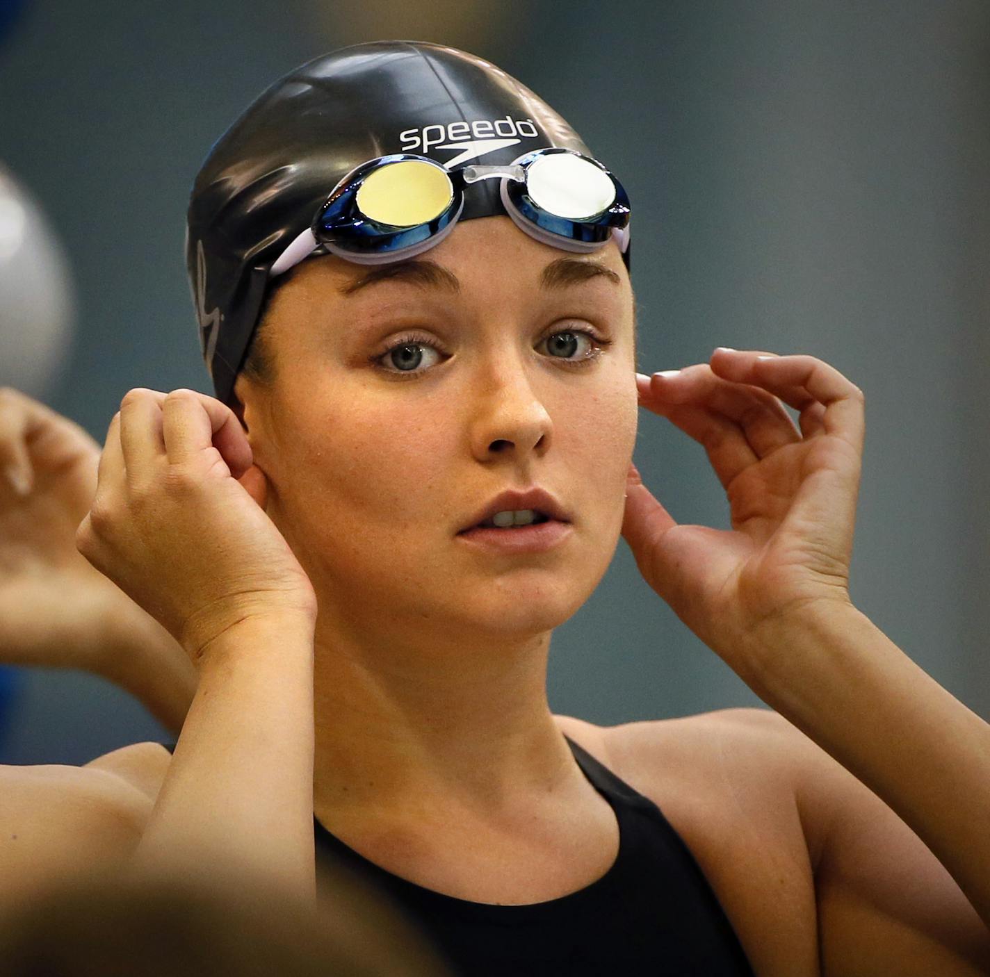 Former Eden Prairie swimmer Rachel Bootsma, now swimming for CAL in the NCAA National Championships at the Uof M, prepares for her first event, prelims of the 200 yard freestyle relay. Here, Bootsma checks her earings before the race like she has done every race before. They were her grandmothers. ] BRIAN PETERSON &#xef; brian.peterson@startribune.com Minneapolis, MN 3/20/2014 ORG XMIT: MIN1403201410301201