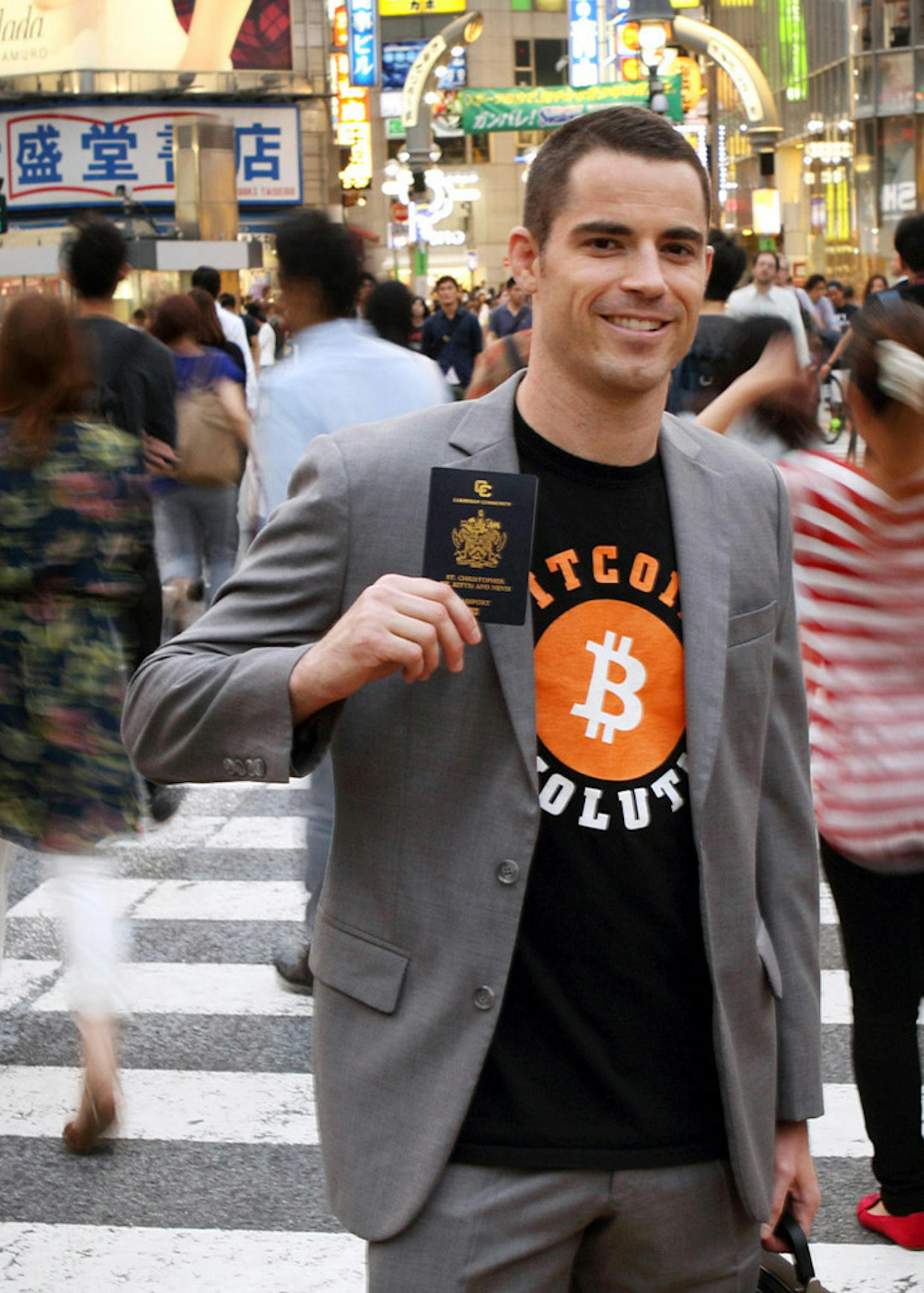 Roger Ver, founder of Passports for Bitcoin.com., holds his passport in Tokyoís Shibuya district. Ver -- known as Bitcoin Jesus in the world of cyber-currencies -- canít promise you heaven, but he is offering a haven: a Caribbean condo that comes with a new passport and almost zero taxes. Illustrates BITCOIN-JESUS (category f) by Jason Clenfield and Pavel Alpeyev © 2014, Bloomberg News. Moved Monday, June 16, 2014. (MUST CREDIT: Bloomberg News photo by Tomohiro Ohsum).