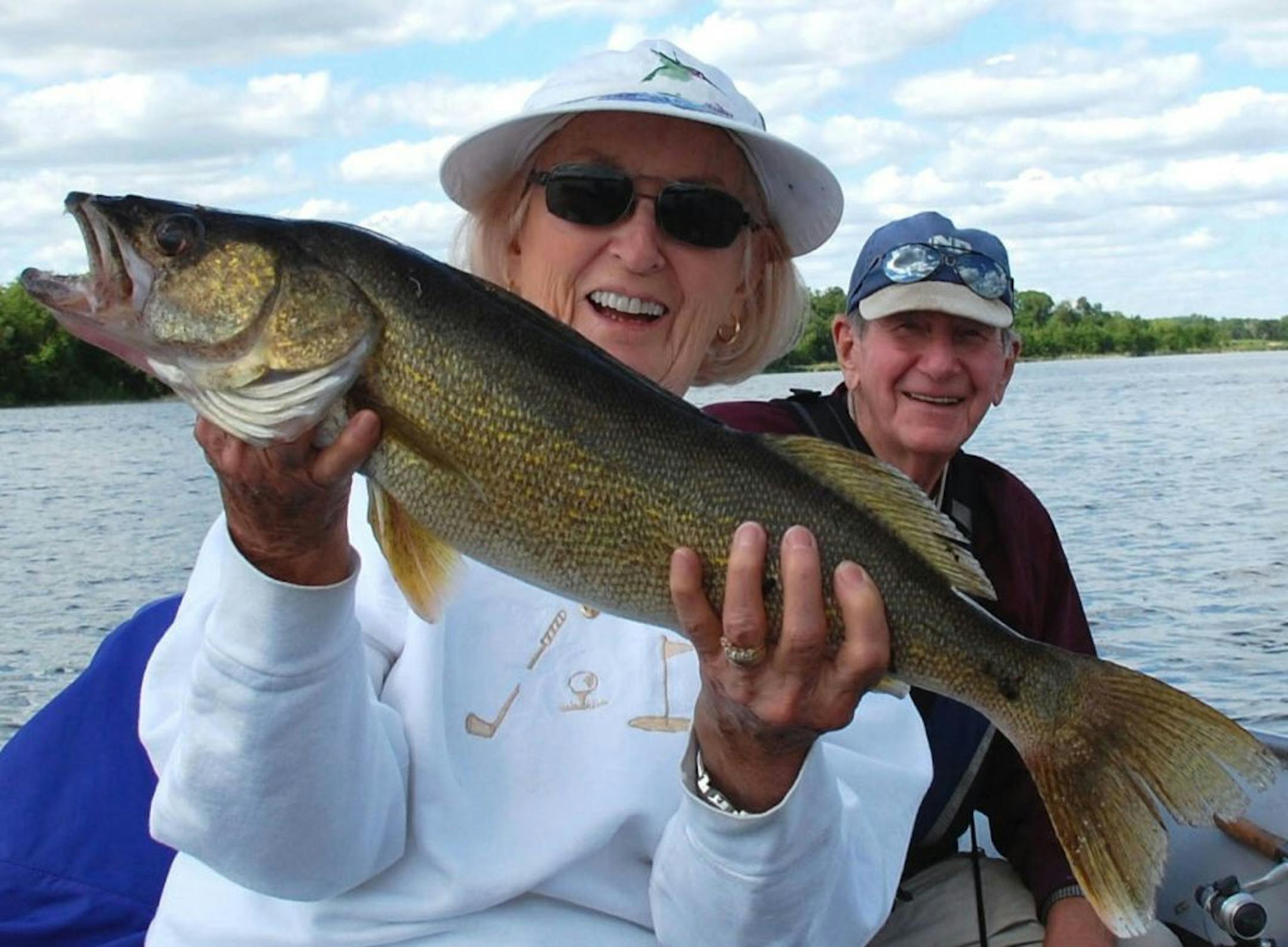 Annabelle Ess of Breezy Point with a 27.5-inch walleye she caught on Nelson Lake. Her husband, Kenny, admires the catch.