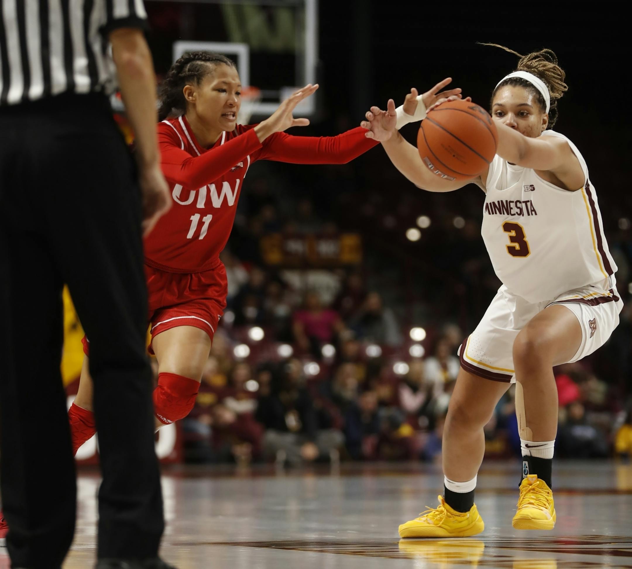 Imani Robinson(11) and Destiny Pitts(3) of the Gophers fight for the ball.
