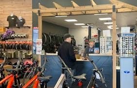 John Sheehan, owner of ROAM Bike Shop in White Bear Lake, right, said questions about the electric bike tax rebate are No. 1 these days.