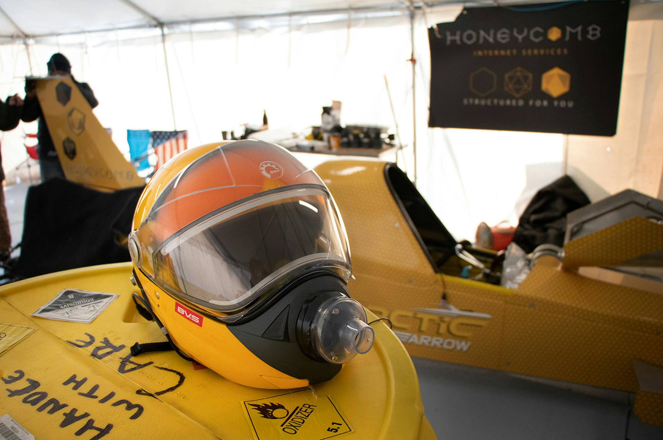 Kurt Anderson�s helmet rests on a rocket fuel container as the Arctic Arrow is reset for its second speed trial on Sunday, Feb. 16, 2020 on Bear Lake in Manawa, WI.