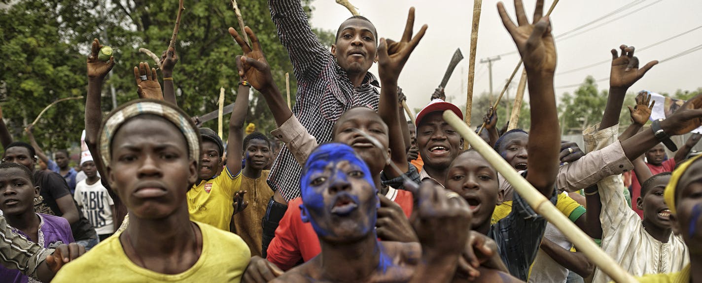 Supporters of Muhammadu Buhari celebrate in the streets a day after election results in Kano, northern Nigeria, April 1, 2015. In most competitive presidential race ever in Nigeria, Buhari delivered a crushing defeat to President Goodluck Jonathan, getting nearly 55 percent of the vote to Jonathan&#xed;s 45 percent. (Samuel Aranda/The New York Times) ORG XMIT: MIN2015040217265858