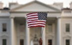 FILE - In this Sept. 2017 file photo, a flag is waved outside the White House, in Washington. The Trump administration announced Friday that it was cu