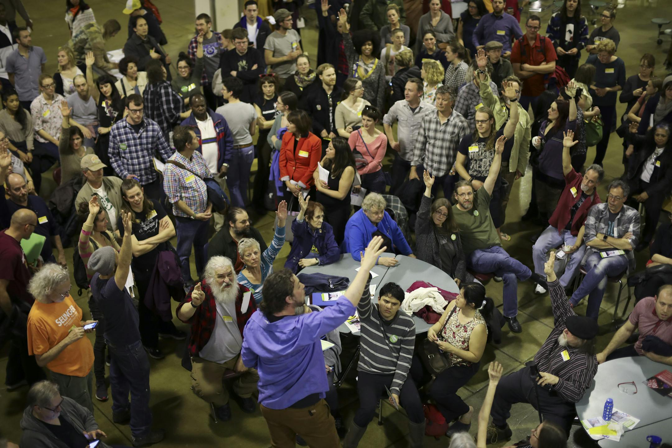 Aaron Spading, 2nd Precinct chair, foreground, was running a caucus for the first time. He asked for a show of hands of those in attendance who were interested in attending the city convention in July. ] JEFF WHEELER ï jeff.wheeler@startribune.com Minneapolis DFLers caucused for City Council, Park Board and mayoral races in Ward 9 at South High School and elsewhere around the city Tuesday evening, April 4, 2017. So many people attended the Precinct 2 caucus that they had to move the caucus