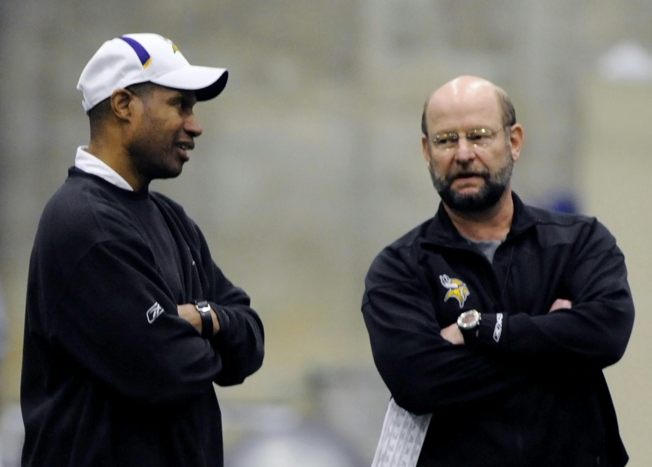 FILE - In a Jan. 14, 2010 file photo, Minnesota Vikings defensive coordinator Leslie Frazier, left, chats with head coach Brad Childress during football practice in Eden Prairie, Minn. Childress was fired late in the season and was replaced by Frazier. (AP Photo/Jim Mone,File) ORG XMIT: MIN2014010419105043
