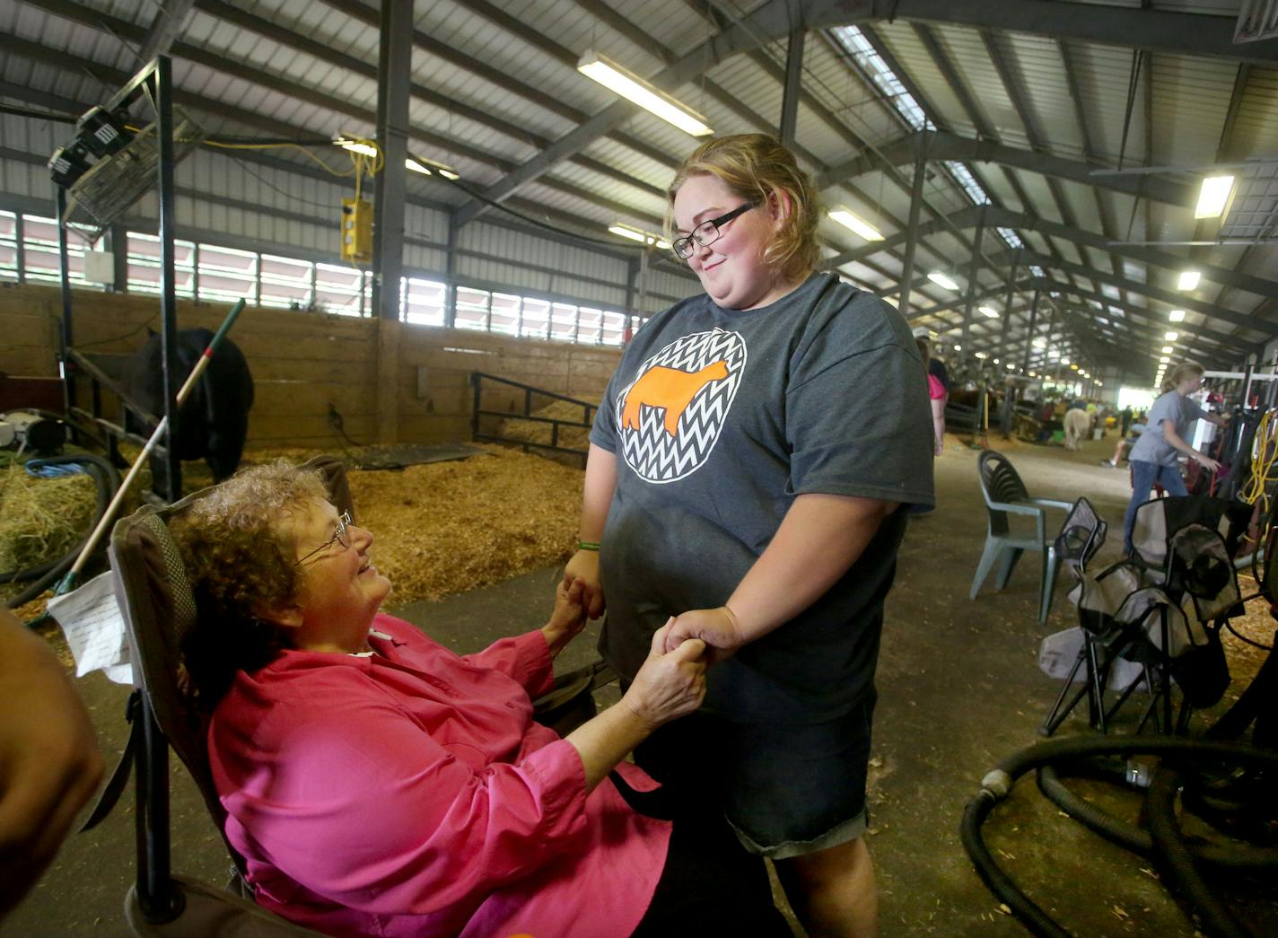 Thousands of outstate Minnesotans will be arriving in a literal cattle call to get their livestock ready for judging on Thursday. Here, Emily Brual, 18, of West Concord, who shows her animals for Dodge County 4-H, greets her grandma Sherrie Robinson, who is in her 70s, in the cattle barn Wednesday, August 23, 2016, at the Minnesota State Fair in Falcon Heights, MN. Three generations of 4-H'ers from the family were on hand at the fair.](DAVID JOLES/STARTRIBUNE)djoles@startribune Nearly 6,000 kids