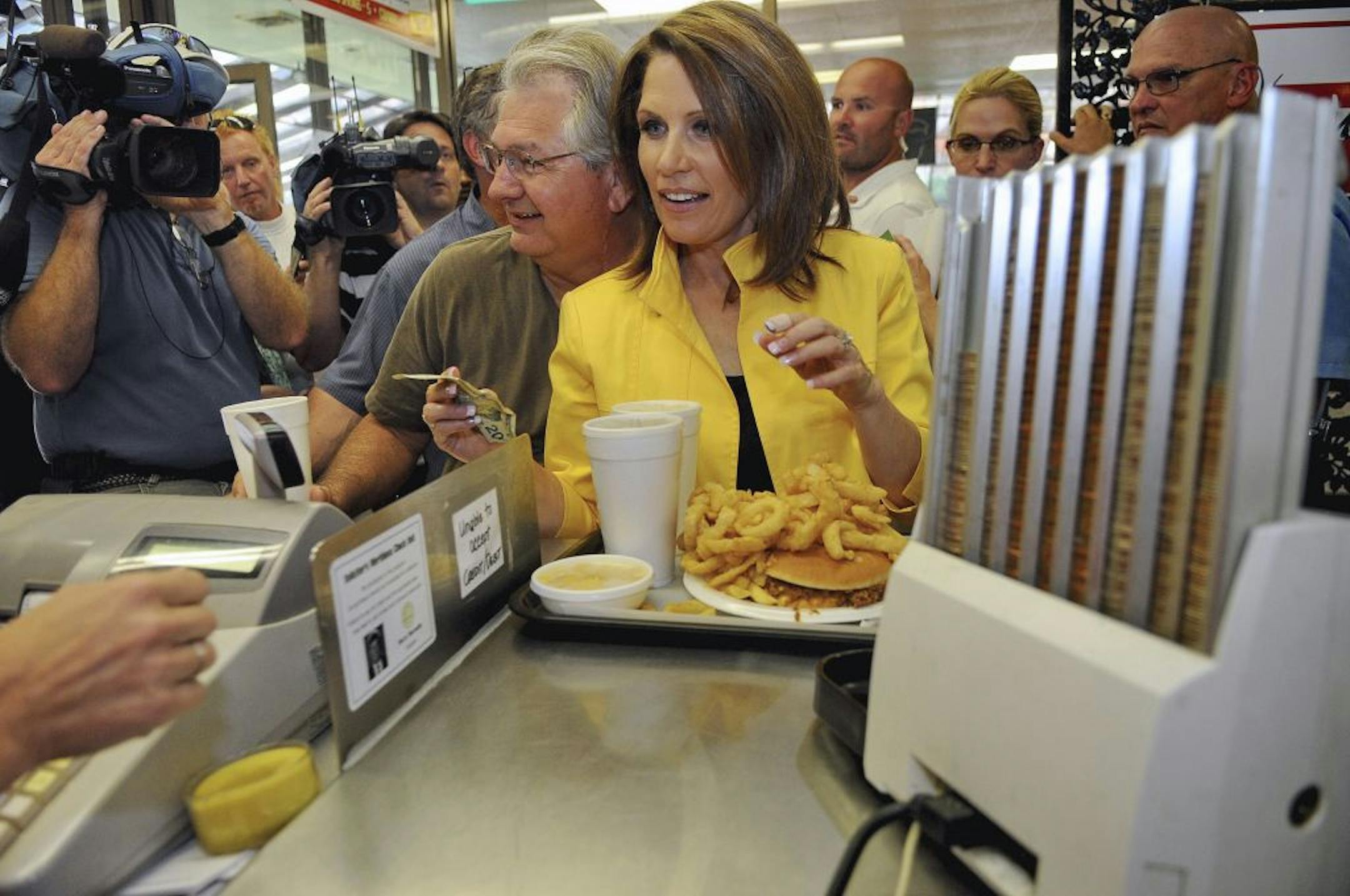 Republican presidential candidate, Rep. Michele Bachmann, R-Minn., pays for her order of Chili Cheese A/Plenty, Tuesday, Aug. 16, 2011, at the Beacon Drive-in , in Spartanburg, S.C.