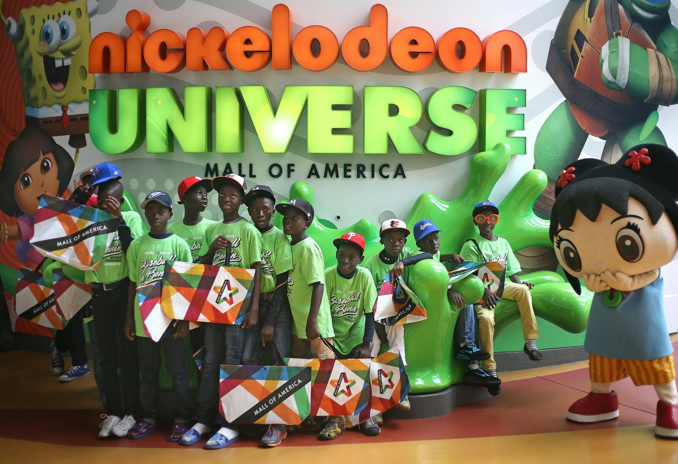 Team Benin has their picture taken with Nickelodeon cartoon character Kai-Lan before an afternoon of riding rollercoasters at the Nickelodeon Universe theme park at the Mall of America on Monday, August 1, 2016 in Bloomington, Minnesota.