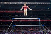 Suni Lee performing her signature move, the Nabieva, in the beginning of her uneven bars routine at the U.S. Olympic gymnastics team trials on June 27