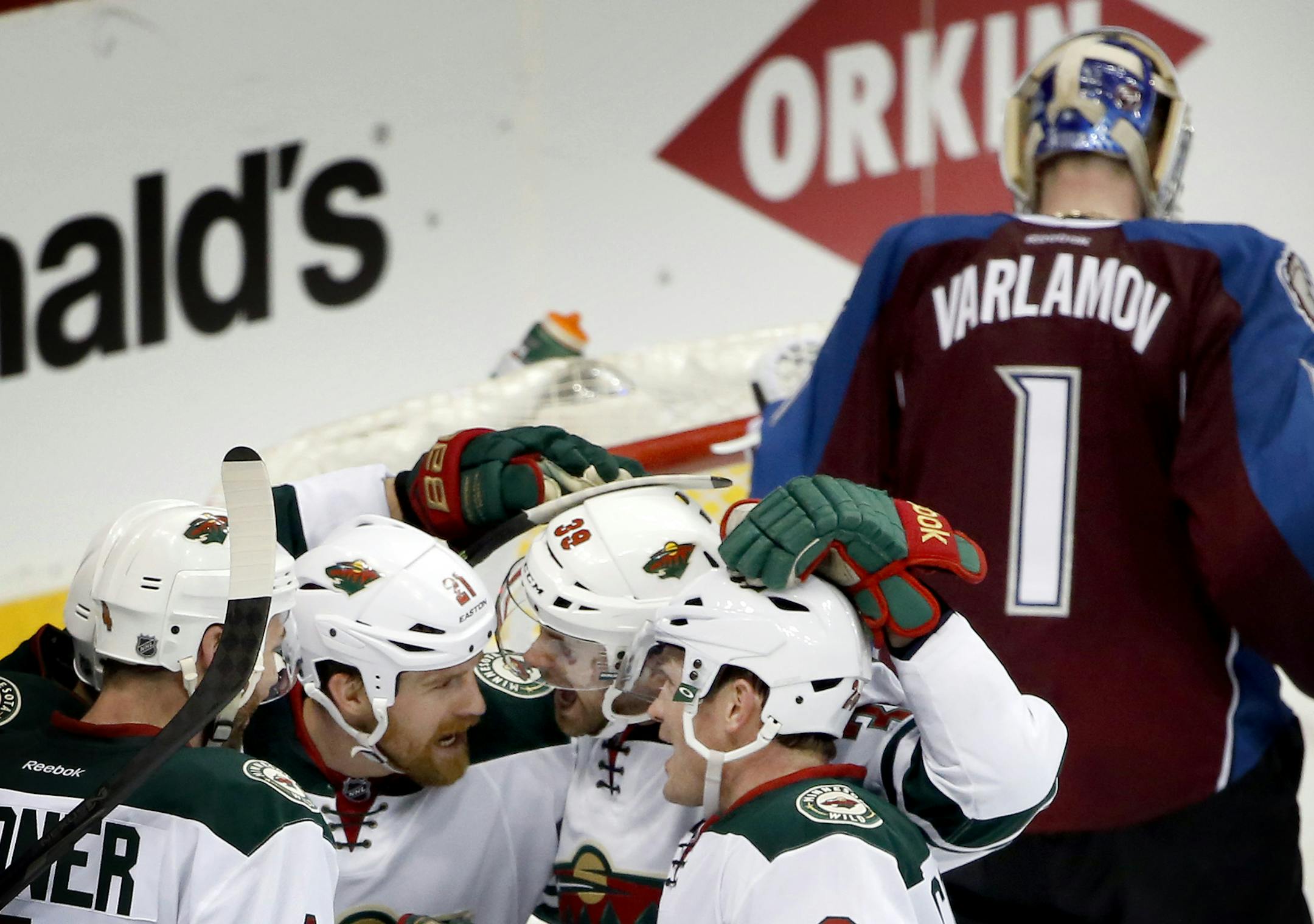 Clayton Stoner (4), Kyle Brodziak (21), Nate Prosser (39) and Matt Cooke (24) celebrated a goal by Brodziak in the second period. ] CARLOS GONZALEZ cgonzalez@startribune.com - April 17, 2014, Denver, Colorado, Pepsi Center, NHL, Minnesota Wild vs. Colorado Avalanche, Stanley Cup Playoffs round 1, Game 1
