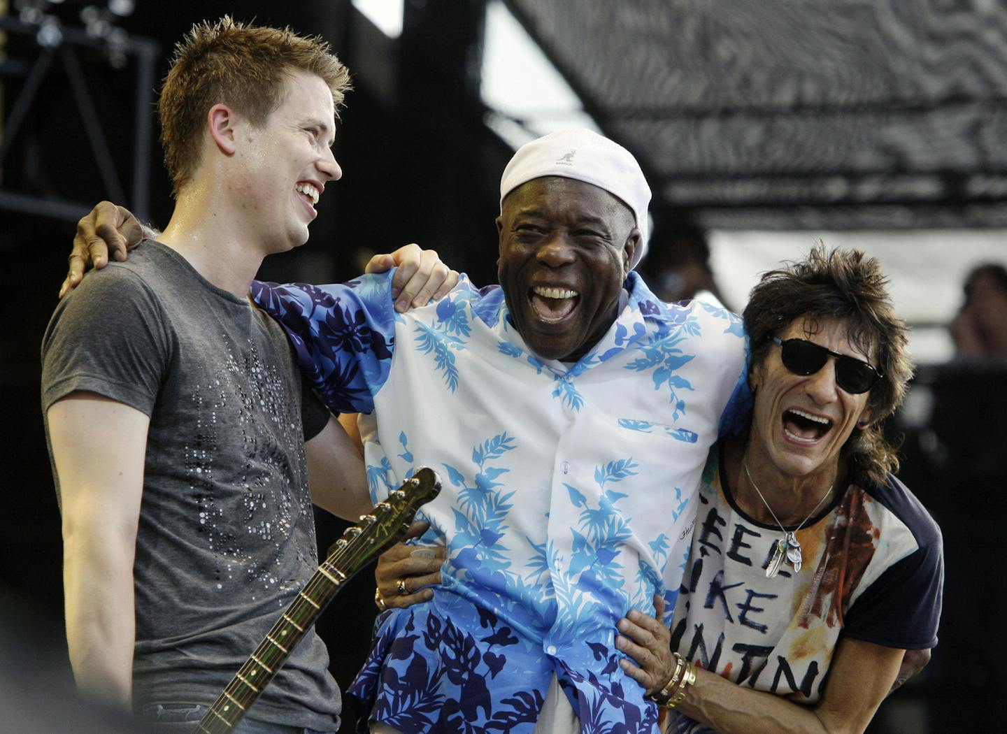 Jonny Lang, left, Buddy Guy, center, and Ronnie Wood laugh after their performance during the Crossroads Guitar Festival Saturday, June 26, 2010 in Chicago. (AP Photo/Kiichiro Sato)