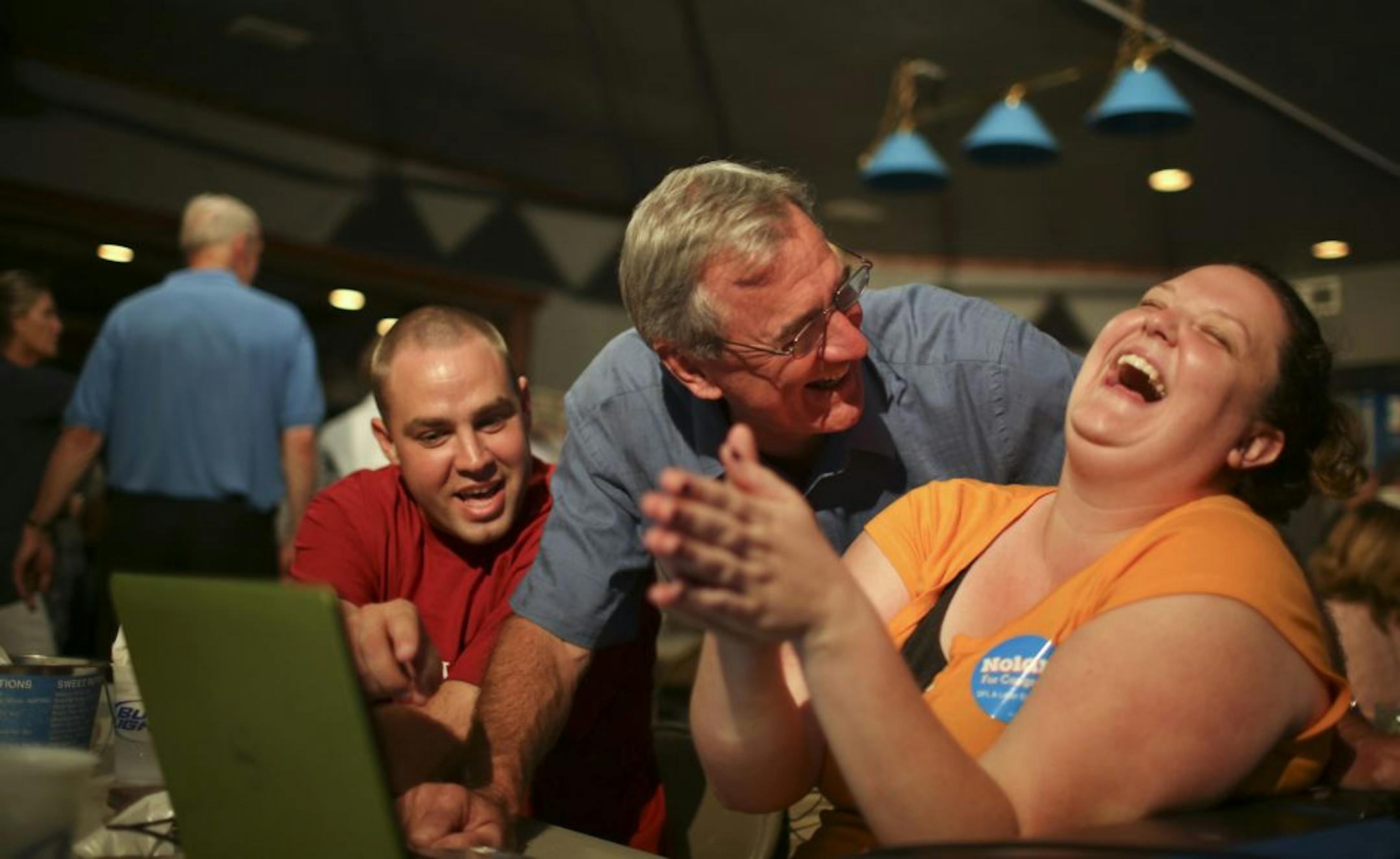 Rick Nolan, the DFL endorsed candidate for congress in the eighth district, held his post-primary party at the Sunshine Kitchen and Moonshine Lounge in Brainerd, Minn. Tuesday night, August 14, 2012. Rick Nolan check on election results over the shoulder of supporter Kelley Stieh of Minneapolis. At left was Tyler Scull of Brainerd.