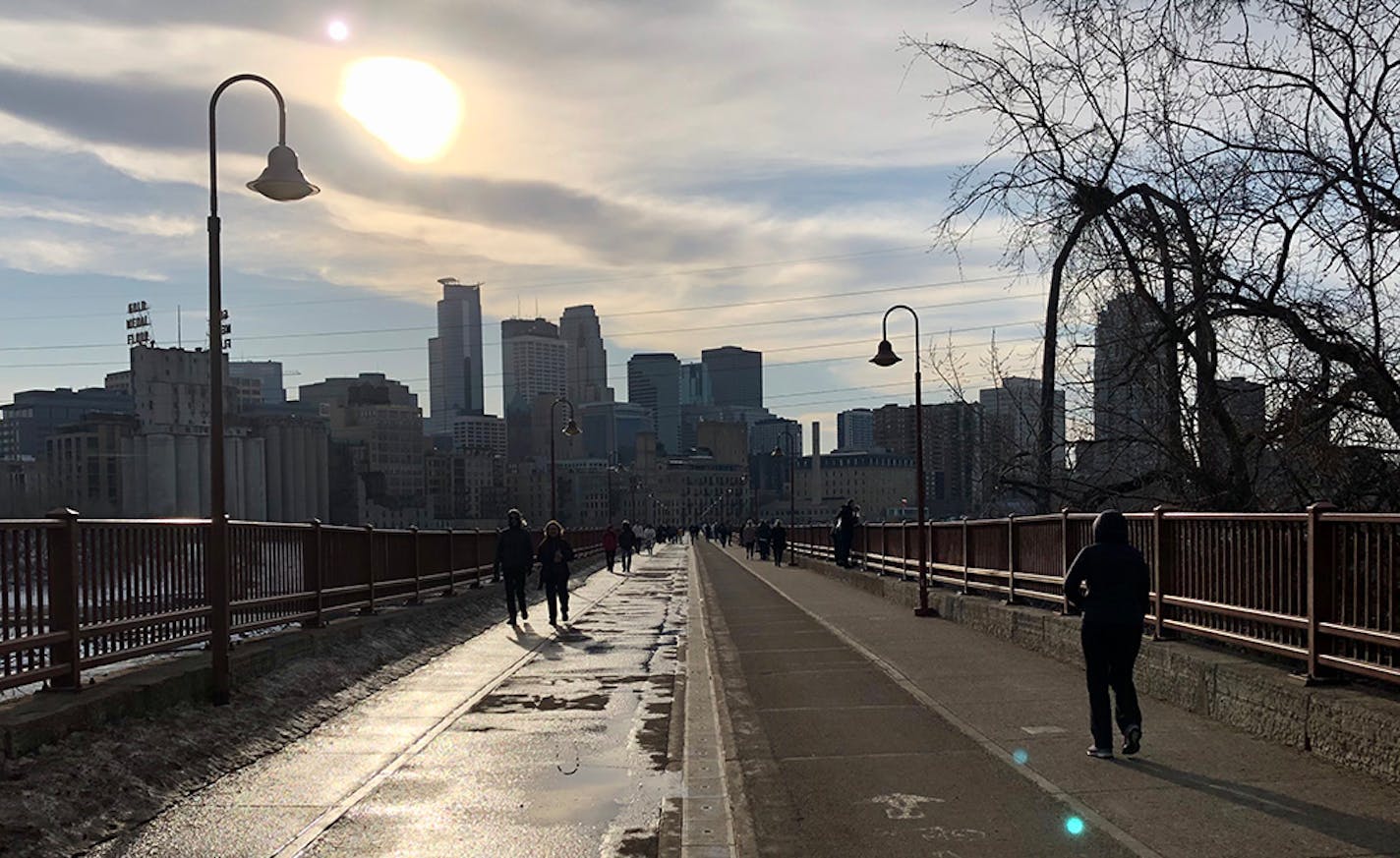 Folks took advantage of Saturday's unseasonably mild weather to enjoy a walk on the Stone Arch Bridge in Minneapolis.