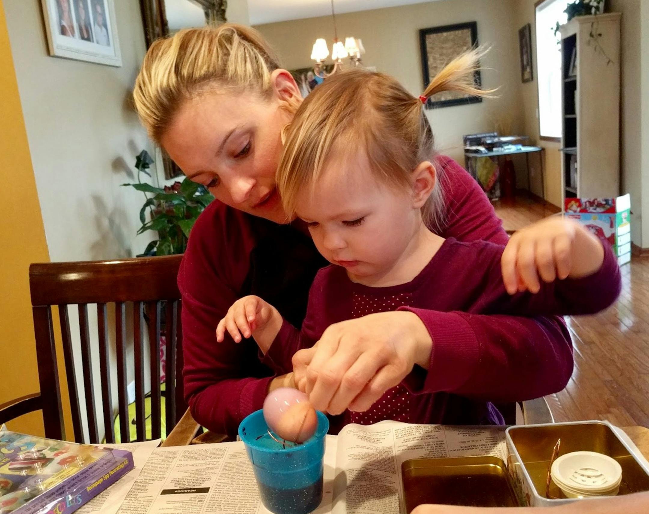 Dianne Damman of Minnetonka sent in this photo of her daughter Lora coloring eggs for this first time with HER daughter, Elli.