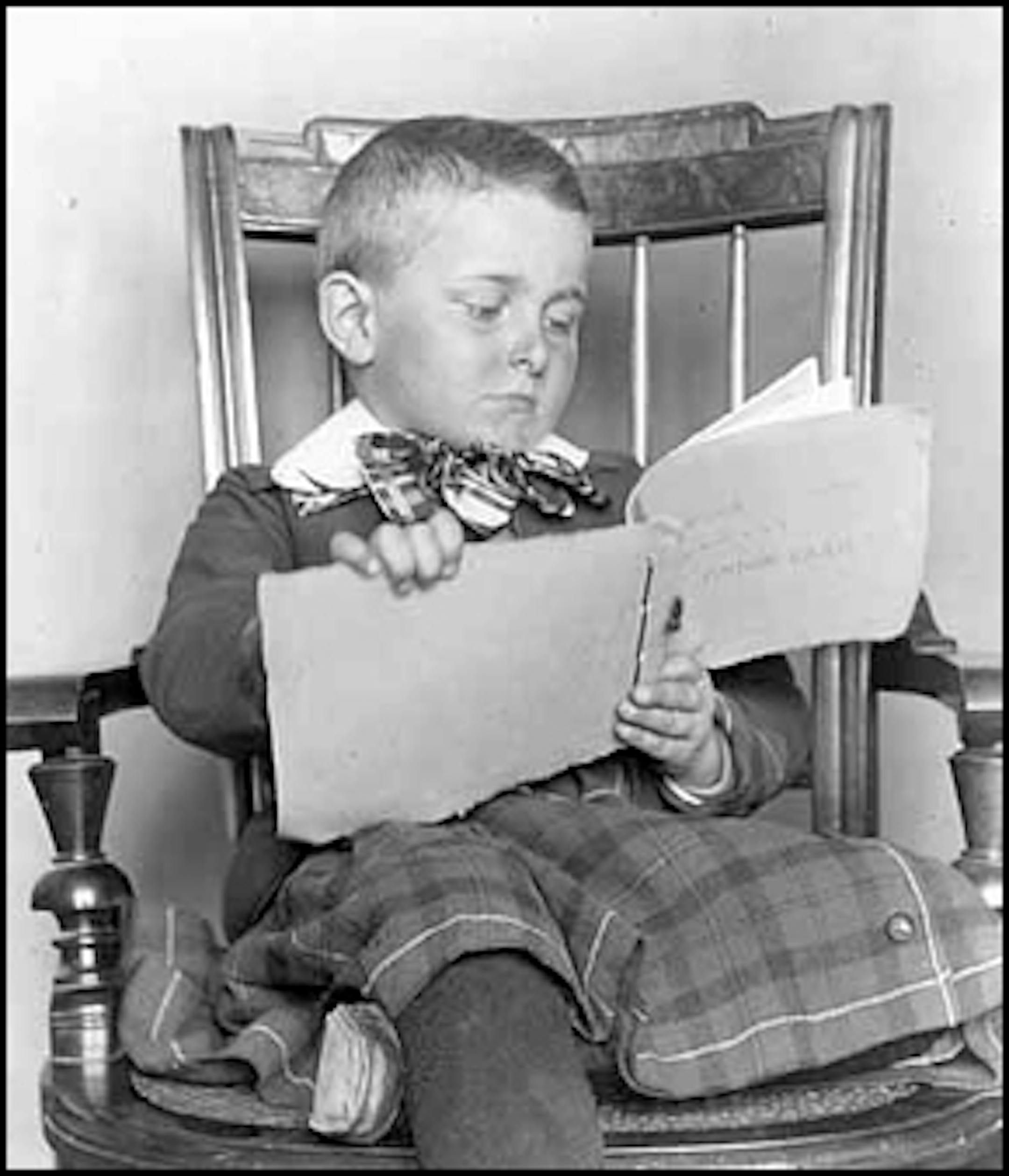 Boy with booklet, about 1890