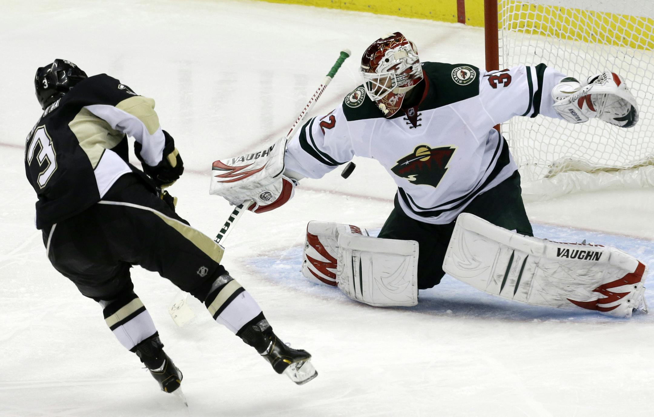 Pittsburgh Penguins' Olli Maatta (3) gets a third-period goal past Minnesota Wild goalie Niklas Backstrom (32) on a penalty shot during an NHL hockey game in Pittsburgh Thursday, Dec. 19, 2013. The Penguins won 5-2. (AP Photo/Gene J. Puskar)